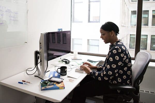 woman on call at computer
