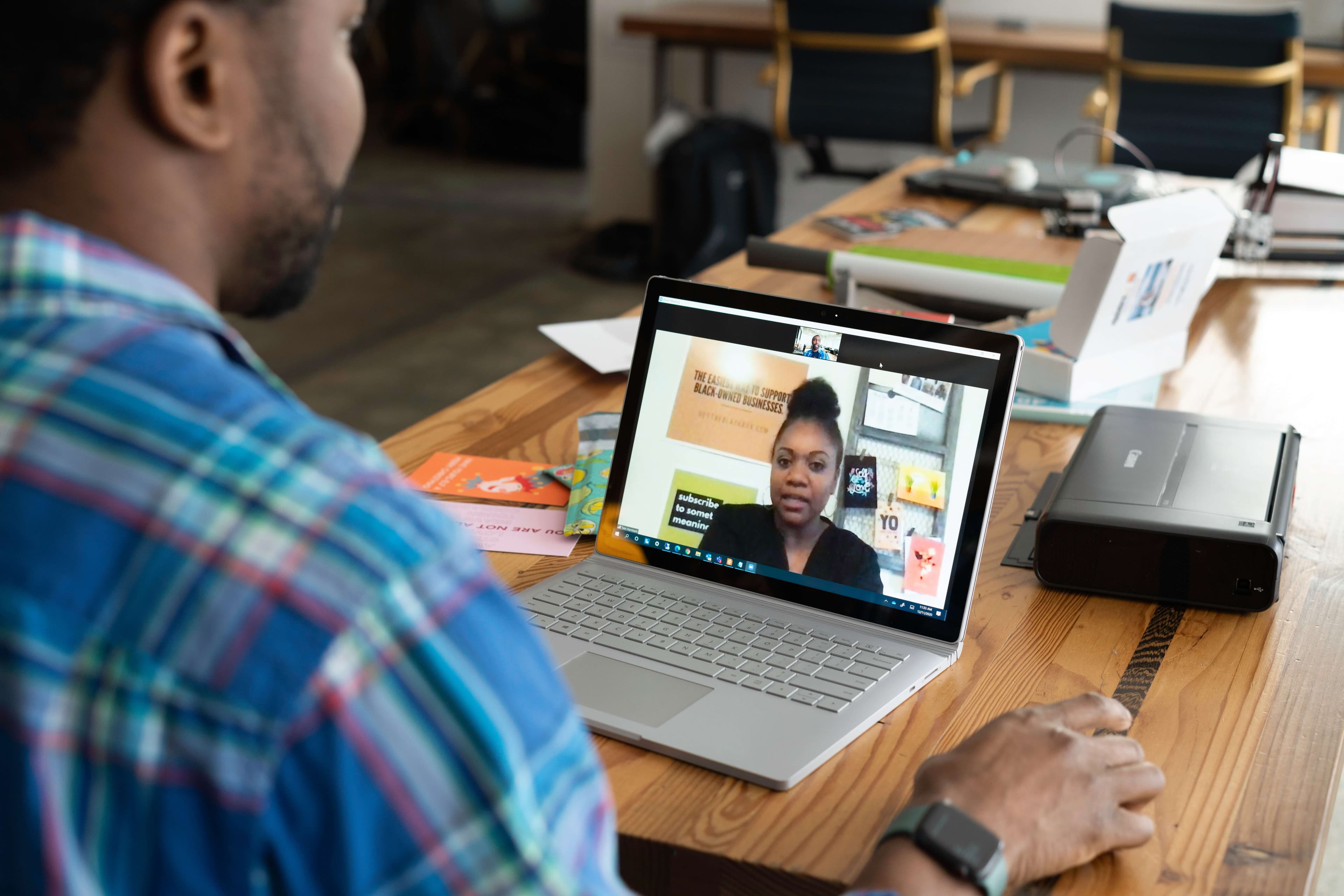 man meeting with his female mentor over laptop video call