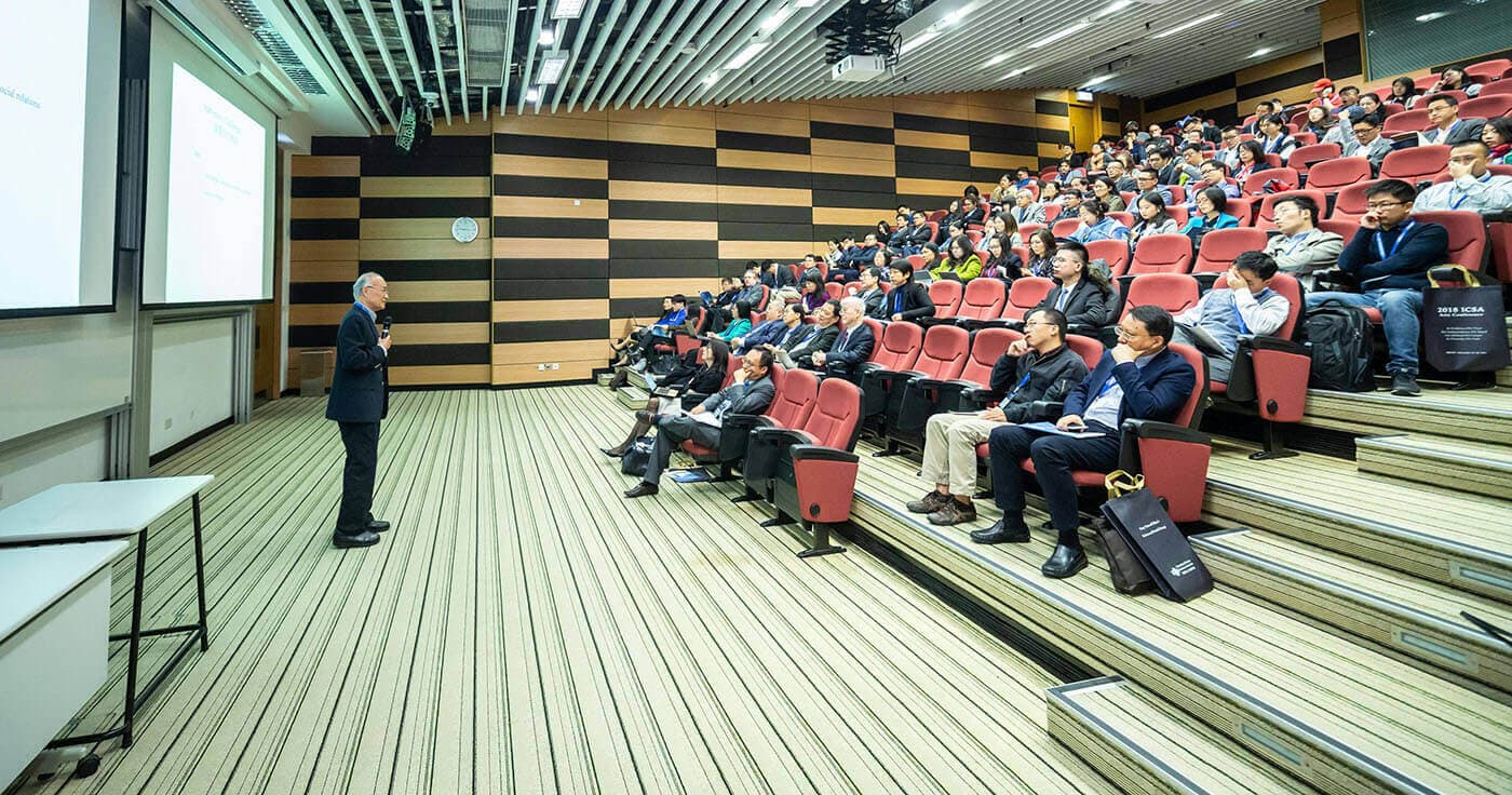 Speaker presenting to a full lecture hall